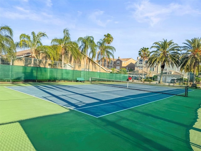view of sport court with fence, community basketball court, and a residential view