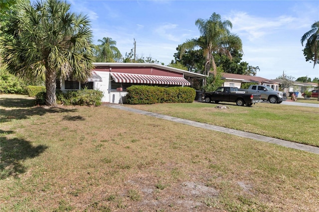 6427 15th St N, Saint Petersburg, FL 33702 - view of front of home with a front lawn and a carport