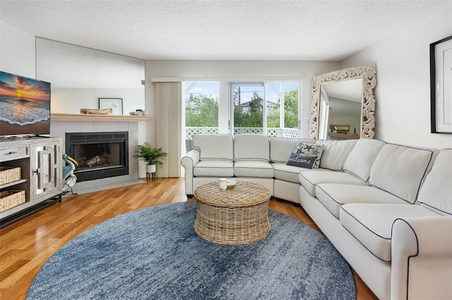 623 Garland Cir, Indian Rocks Beach, FL 33785 - living room with a fireplace, wood finished floors, and a textured ceiling