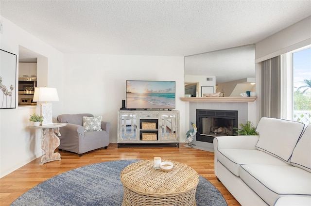 623 Garland Cir, Indian Rocks Beach, FL 33785 - living room featuring a fireplace, wood finished floors, and a textured ceiling