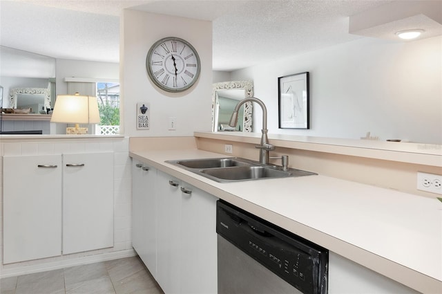 623 Garland Cir, Indian Rocks Beach, FL 33785 - kitchen with stainless steel dishwasher, a sink, white cabinets, a textured ceiling, and light countertops