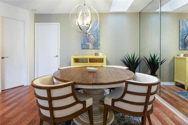 623 Garland Cir, Indian Rocks Beach, FL 33785 - dining room with a skylight, wood finished floors, and a chandelier