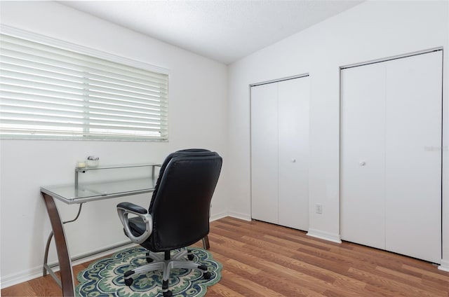 623 Garland Cir, Indian Rocks Beach, FL 33785 - home office featuring wood finished floors, a textured ceiling, and baseboards