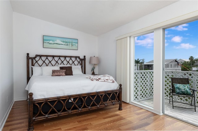 623 Garland Cir, Indian Rocks Beach, FL 33785 - bedroom featuring vaulted ceiling, wood finished floors, access to outside, and baseboards
