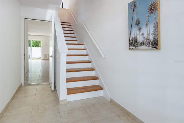 623 Garland Cir, Indian Rocks Beach, FL 33785 - staircase featuring baseboards and tile patterned flooring