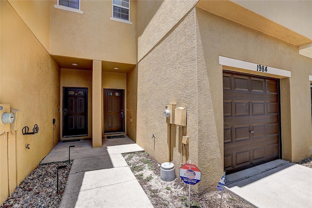 entrance to property featuring stucco siding