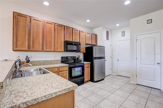 kitchen with recessed lighting, light countertops, a sink, light tile patterned floors, and black appliances