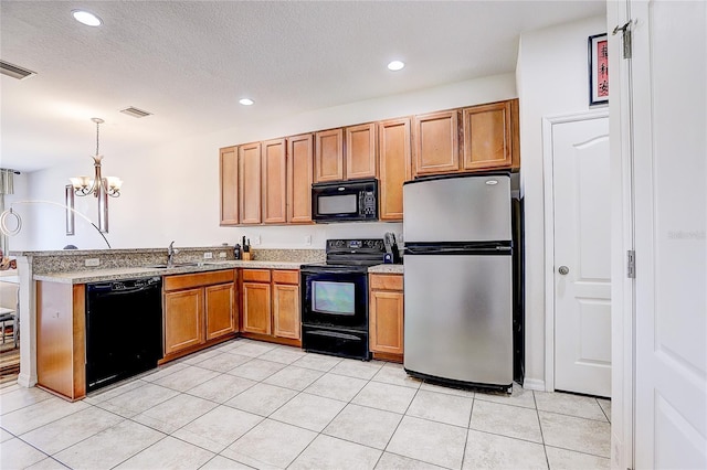 kitchen with pendant lighting, a sink, black appliances, a peninsula, and a chandelier