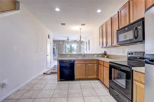 kitchen with visible vents, a peninsula, light countertops, a sink, and black appliances