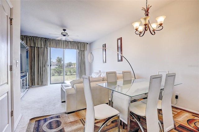 dining space with carpet flooring and ceiling fan with notable chandelier