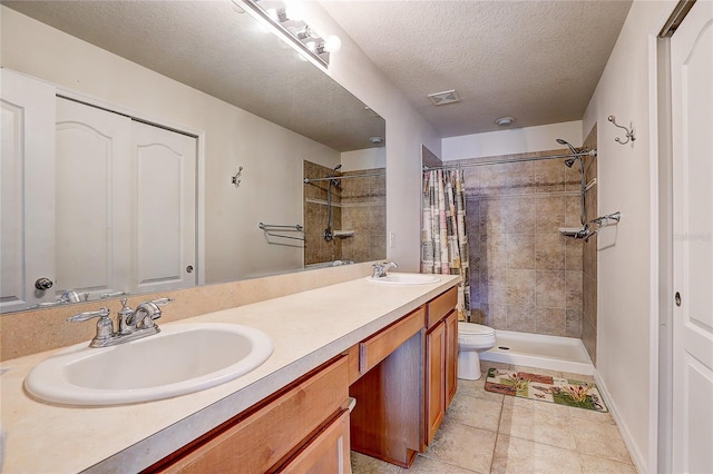 full bath with tiled shower, toilet, visible vents, and a sink