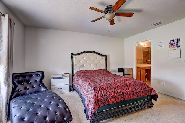 bedroom with carpet flooring, a ceiling fan, baseboards, ensuite bathroom, and visible vents