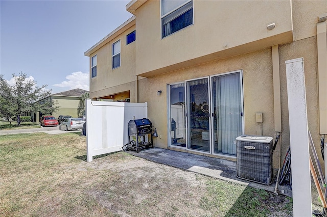 back of property with central air condition unit and stucco siding