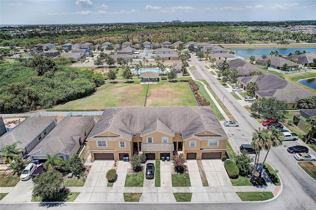 drone / aerial view featuring a water view and a residential view