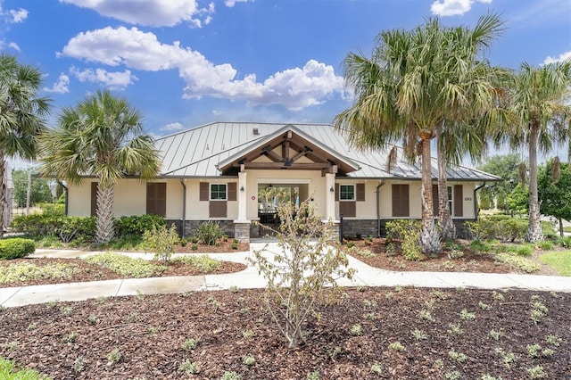 11626 Blue Woods Dr, Riverview, FL 33569 - view of front of home featuring a standing seam roof, stone siding, stucco siding, and metal roof