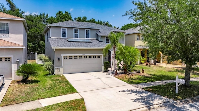 10636 Dawns Light Dr, Riverview, FL 33578 - traditional-style house with stucco siding, an attached garage, driveway, a front lawn, and roof with shingles