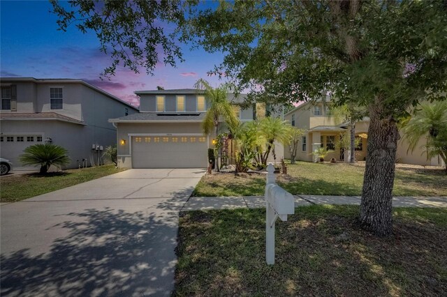 10636 Dawns Light Dr, Riverview, FL 33578 - traditional-style home with driveway, stucco siding, a garage, and a lawn