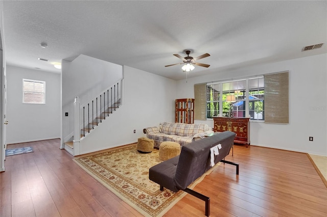 10636 Dawns Light Dr, Riverview, FL 33578 - living room with stairs, a ceiling fan, hardwood / wood-style floors, and baseboards