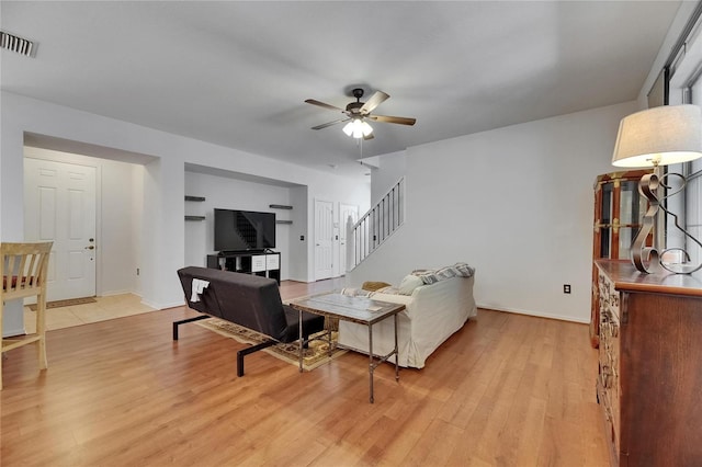 10636 Dawns Light Dr, Riverview, FL 33578 - living area with stairs, ceiling fan, light wood-style floors, and baseboards