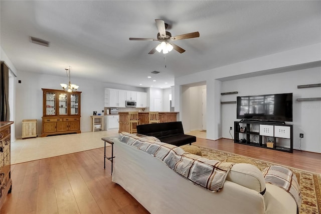 10636 Dawns Light Dr, Riverview, FL 33578 - living room featuring ceiling fan, a chandelier, and light wood finished floors