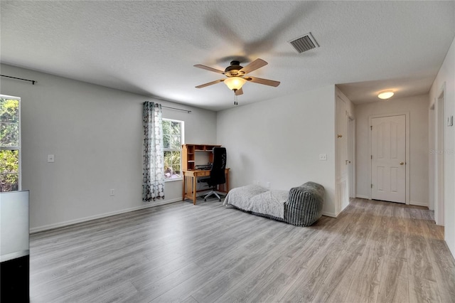 10636 Dawns Light Dr, Riverview, FL 33578 - living area featuring light wood-style flooring, plenty of natural light, a ceiling fan, and a textured ceiling