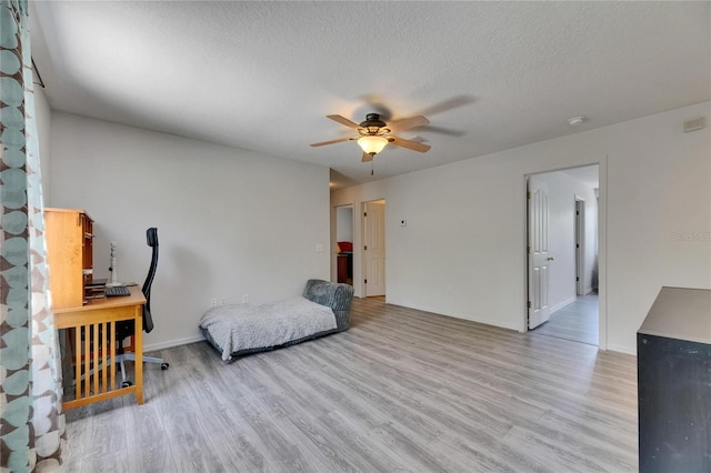 10636 Dawns Light Dr, Riverview, FL 33578 - sitting room featuring light wood finished floors, ceiling fan, a textured ceiling, and baseboards