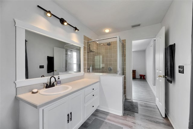 10636 Dawns Light Dr, Riverview, FL 33578 - full bath with a stall shower, vanity, and wood finished floors