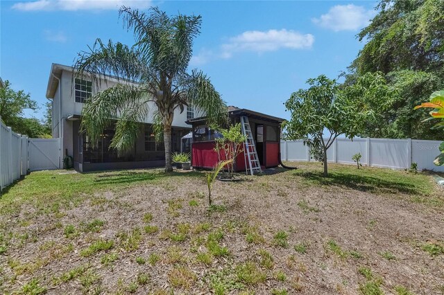 10636 Dawns Light Dr, Riverview, FL 33578 - fenced backyard featuring a gate, a sunroom, an outbuilding, and a shed
