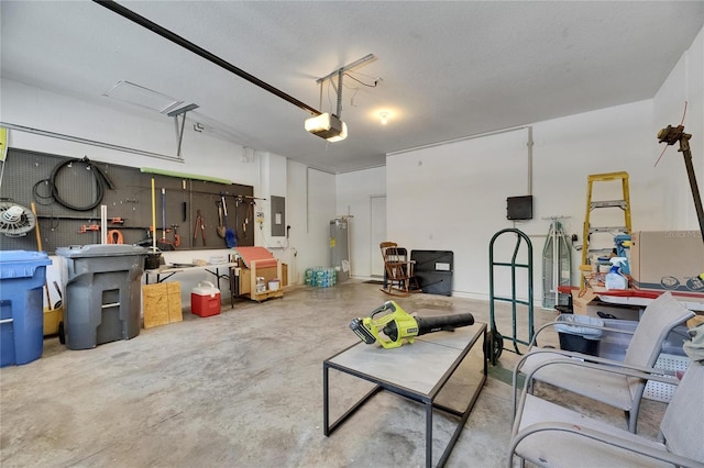 10636 Dawns Light Dr, Riverview, FL 33578 - garage featuring a garage door opener, water heater, a workshop area, and electric panel