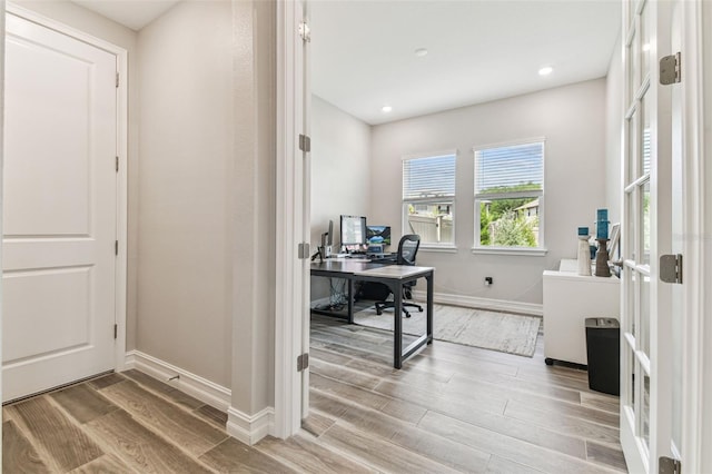 office space with light wood-style flooring, baseboards, and recessed lighting