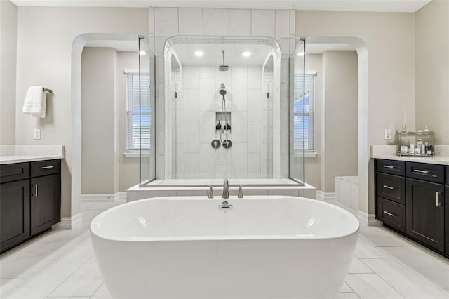 full bath featuring a freestanding bath, a shower stall, and vanity