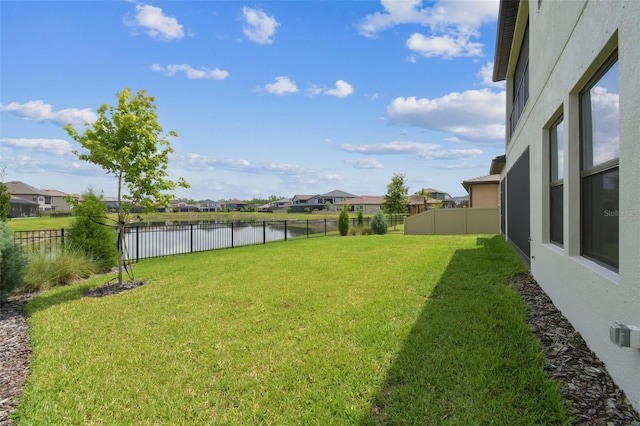view of yard featuring a water view and a residential view