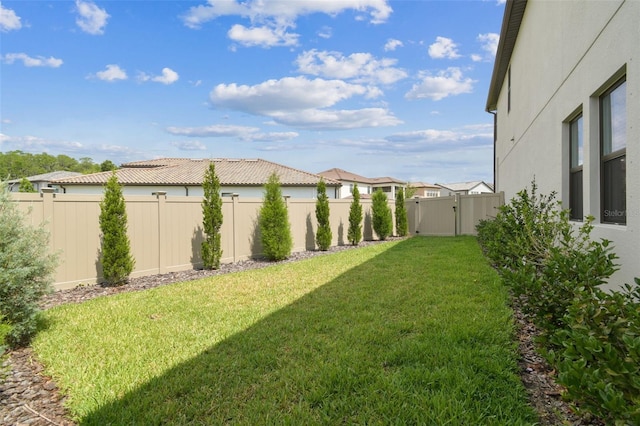 view of yard featuring a gate and a residential view