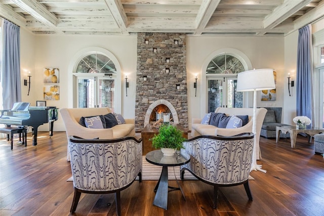 sitting room with dark wood-style floors, a fireplace, plenty of natural light, beam ceiling, and coffered ceiling