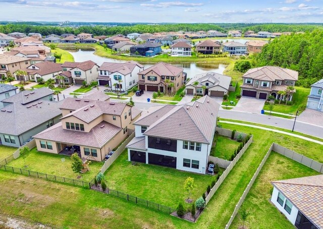 aerial view of residential area featuring a nearby body of water