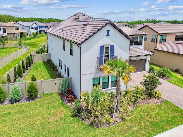 29895 Picana Ln, Wesley Chapel, FL 33543 - view of front facade featuring a gate, decorative driveway, stucco siding, a garage, and a residential view