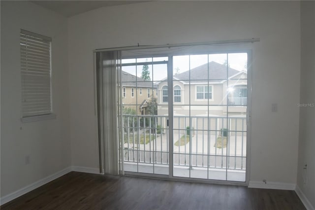 interior space featuring baseboards and dark wood-style floors