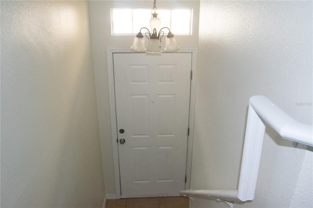 doorway featuring an inviting chandelier