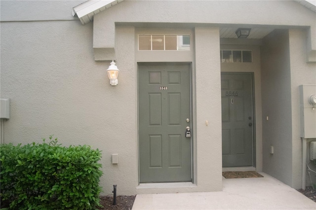 property entrance with stucco siding
