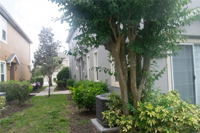 view of yard featuring central air condition unit