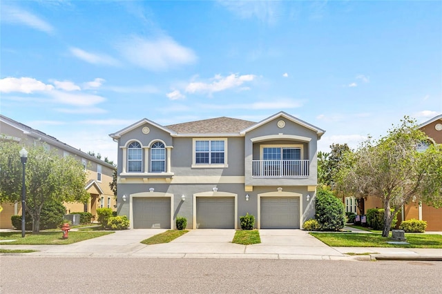 8848 Moonlit Meadows Loop, Riverview, FL 33578 - view of front of home featuring driveway, an attached garage, and stucco siding