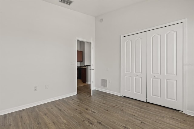 8848 Moonlit Meadows Loop, Riverview, FL 33578 - unfurnished bedroom with wood finished floors, baseboards, and a closet