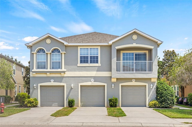 8848 Moonlit Meadows Loop, Riverview, FL 33578 - view of front of property with driveway, stucco siding, an attached garage, and a shingled roof