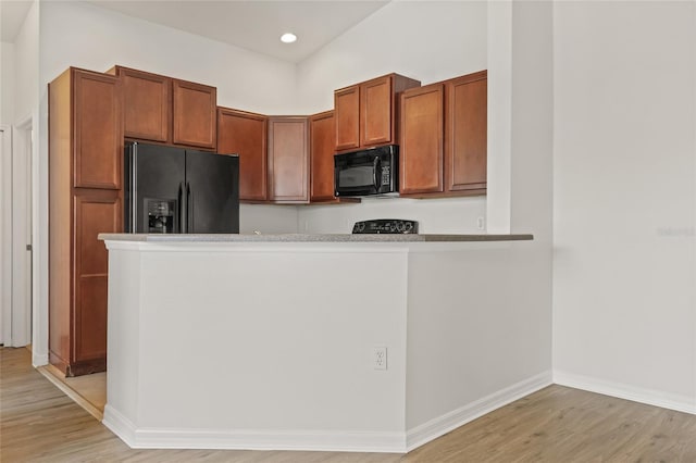 8848 Moonlit Meadows Loop, Riverview, FL 33578 - kitchen featuring black appliances, light wood-type flooring, brown cabinetry, baseboards, and recessed lighting