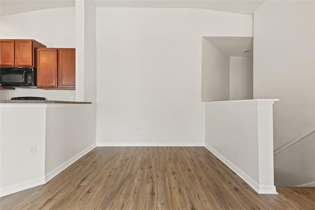 8848 Moonlit Meadows Loop, Riverview, FL 33578 - unfurnished dining area featuring vaulted ceiling, wood finished floors, and baseboards