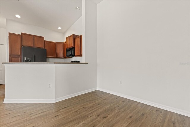 8848 Moonlit Meadows Loop, Riverview, FL 33578 - kitchen featuring black appliances, light wood-style floors, recessed lighting, baseboards, and brown cabinets