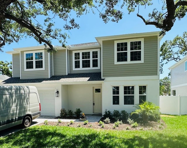 view of front of home featuring a front yard, a garage, fence, a shingled roof, and stucco siding
