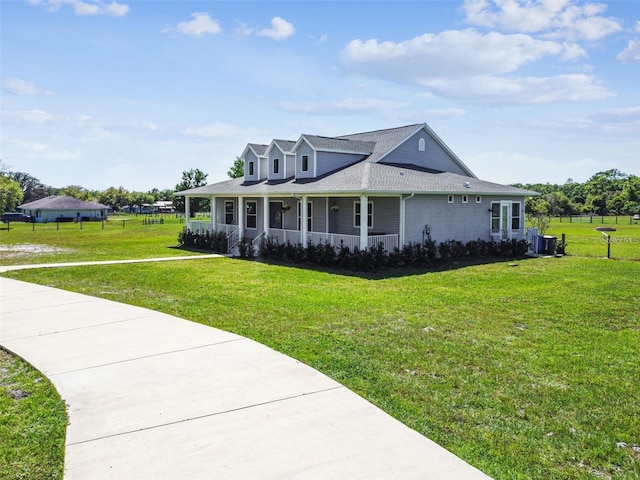 view of front facade featuring covered porch, cooling unit, a shingled roof, and a front lawn