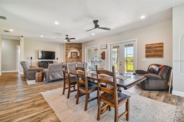 dining area with ceiling fan, french doors, light wood-style flooring, and visible vents