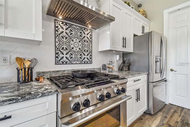 kitchen featuring gas stove, dark wood finished floors, wall chimney exhaust hood, white cabinetry, and backsplash